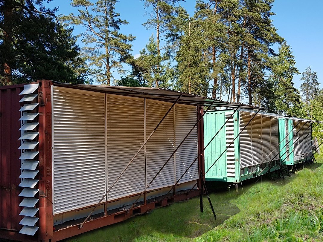 Three containers on grass